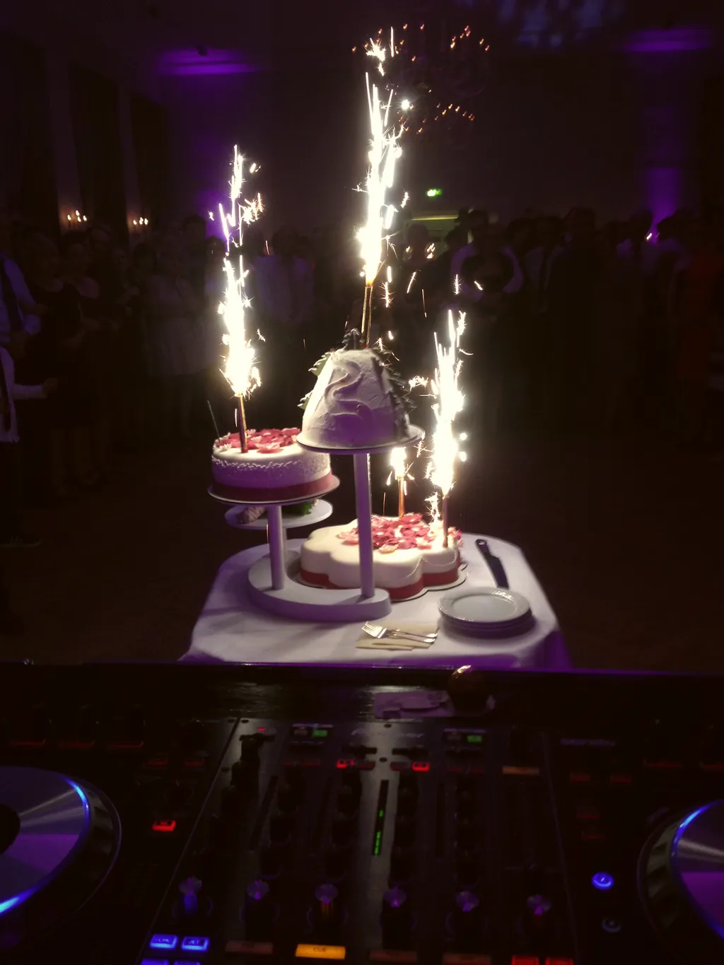 Hochzeitstorte mit Tischfeuerwerk vor dem DJ-Pult Hochzeitstorte mit Tischfeuerwerk vor dem DJ-Pult